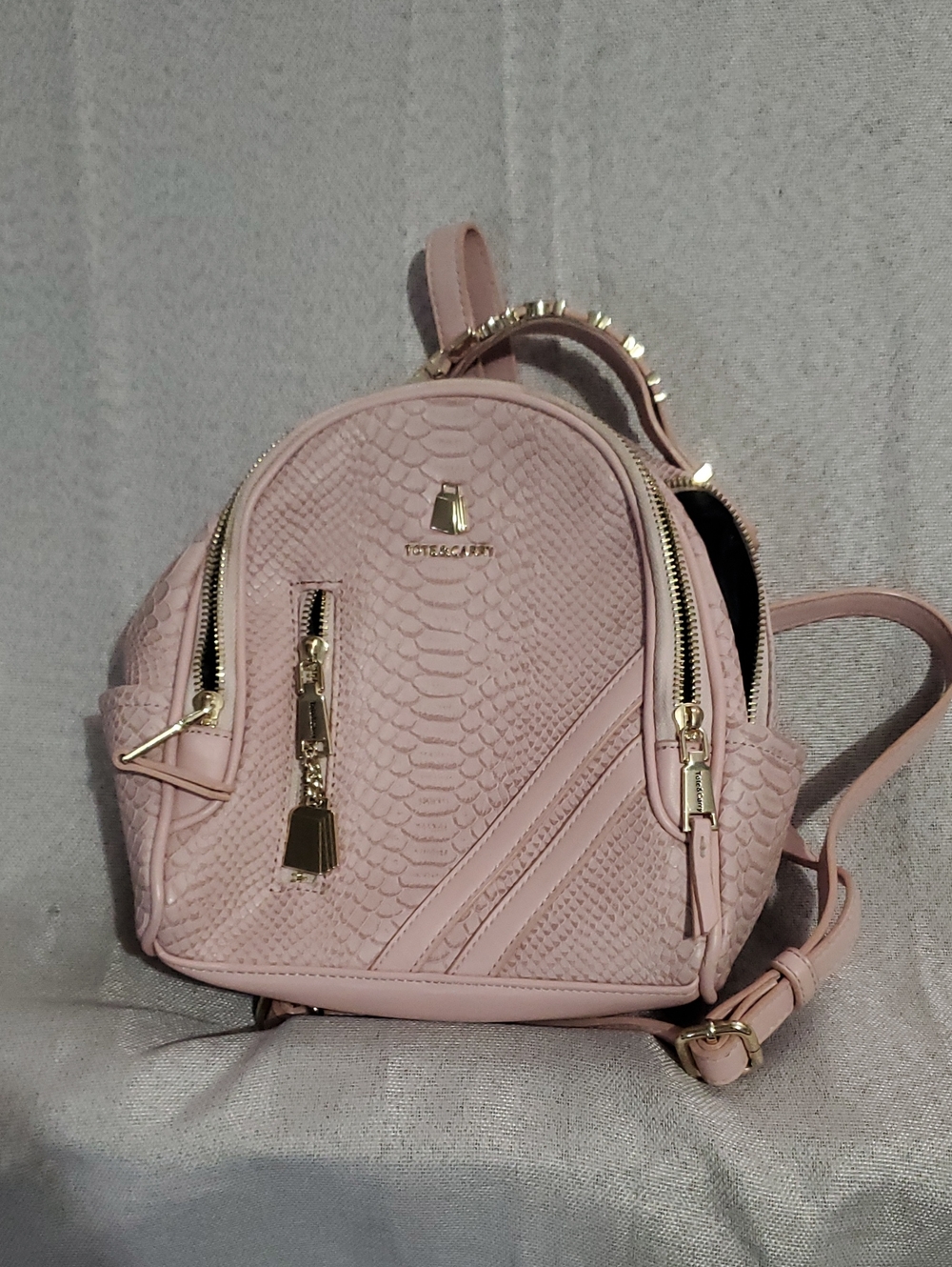 Tote & Carry Pink Textured Mini Backpack with Gold Accents